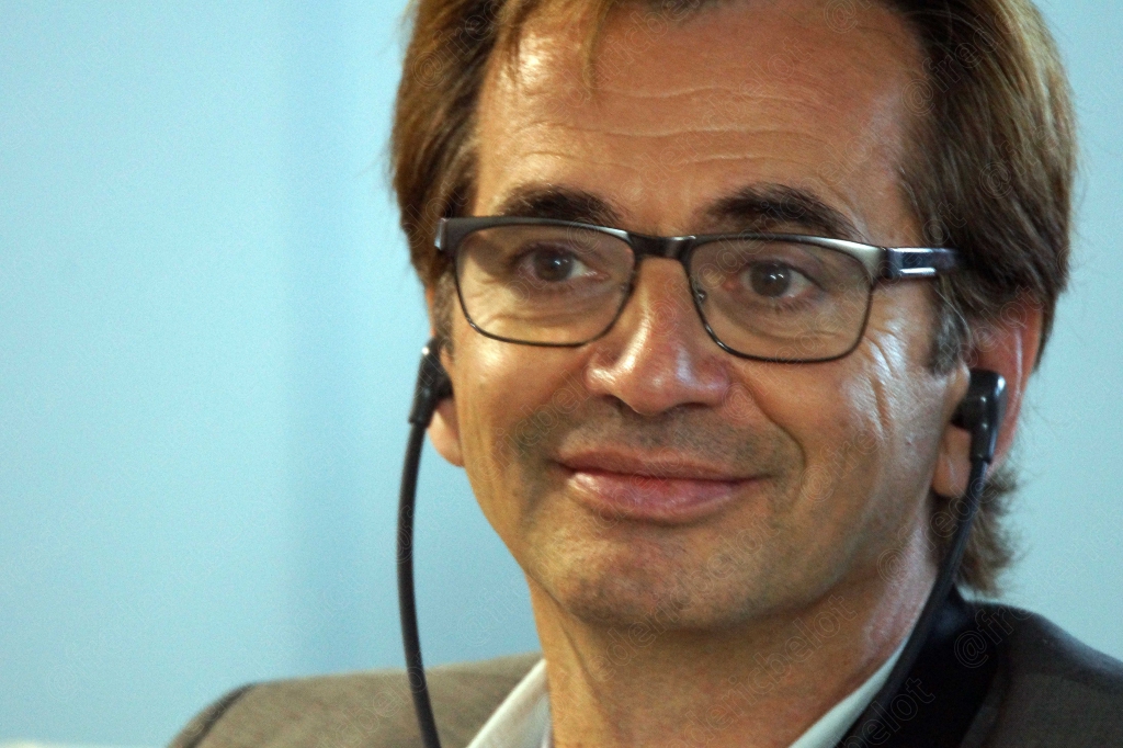 Homme à lunettes souriant, dans le public