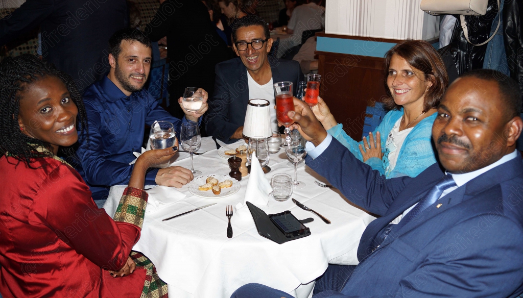 Un groupe de convives lève ses verres pour un toast joyeux.